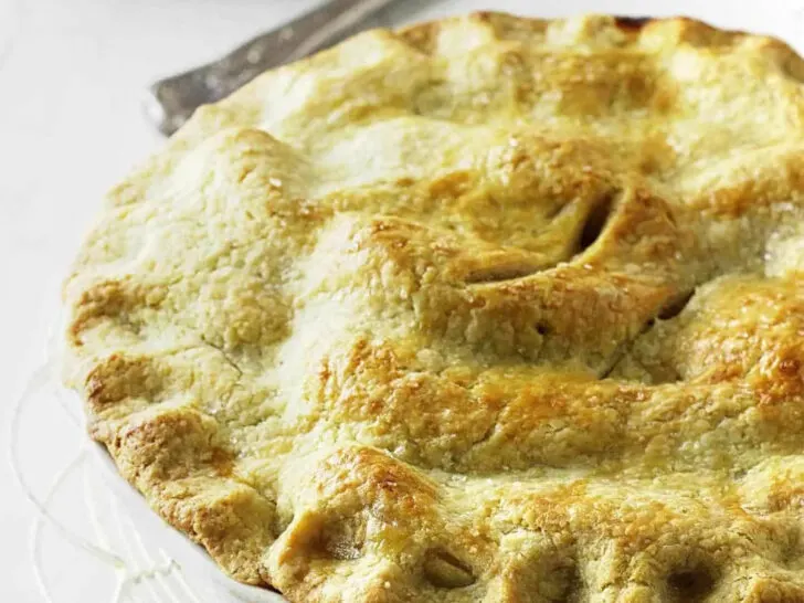 Golden brown einkorn pie crust on top of a fruit pie.