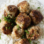 Homemade frozen meatballs reheated and served on rice.