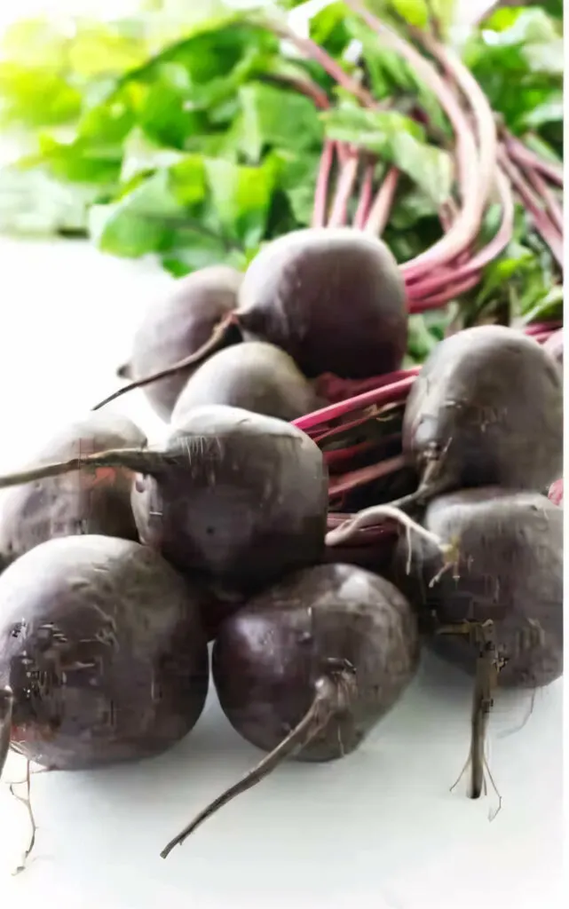 Fresh beets with the stem and leaves attached.