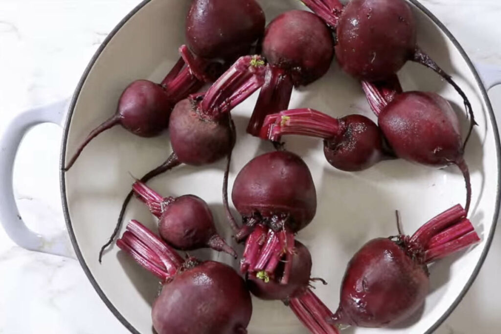 Tossing beets in a Dutch oven.