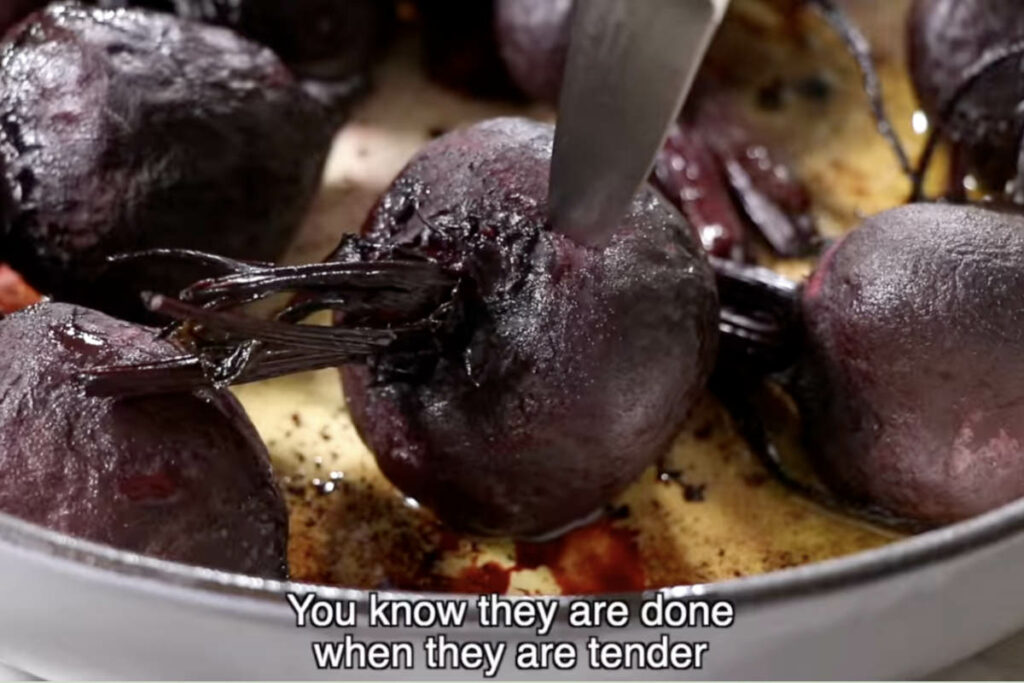 Checking roasted beets for doneness.