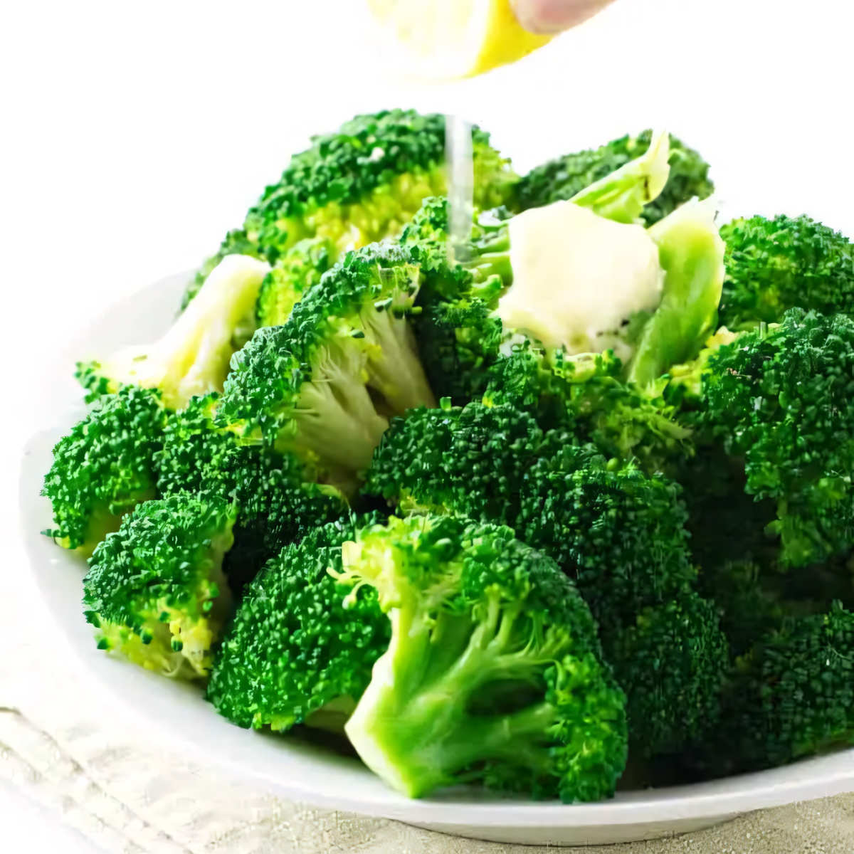 Freshly steamed broccoli with a pat of butter and lemon juice.