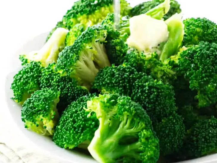 A serving of freshly steamed broccoli with a squeeze of lemon.