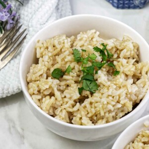 A bowl of sprouted brown rice topped with parsley.