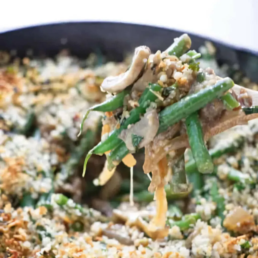 A spoon scooping up a low fat green bean casserole.