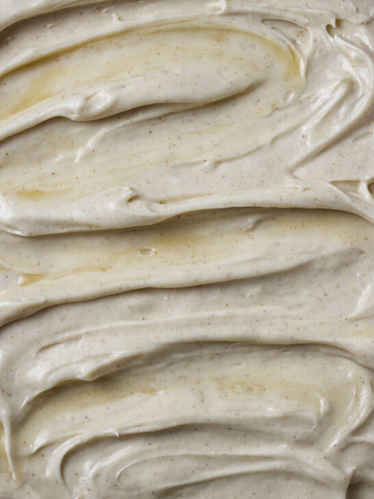 A swirl of maple cream cheese frosting on the top of a cake.