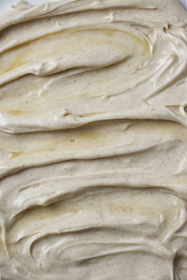 A swirl of maple cream cheese frosting on the top of a cake.