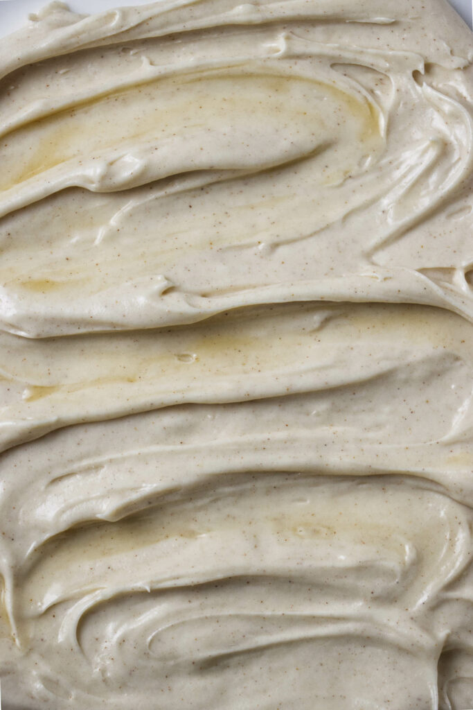 A swirl of maple cream cheese frosting on the top of a cake.