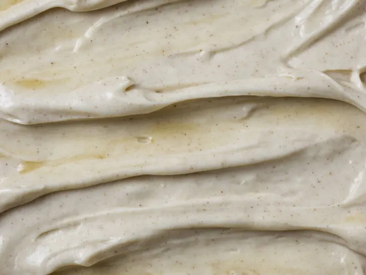 A swirl of maple cream cheese frosting on the top of a cake.