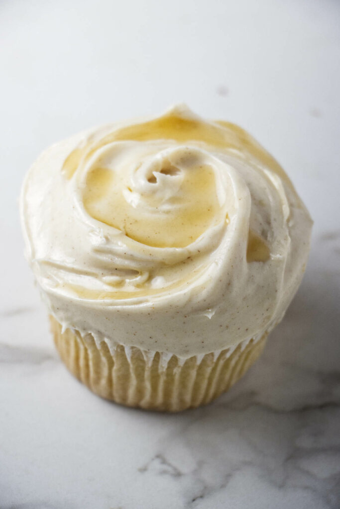 Maple cream cheese icing on top of a cupcake.