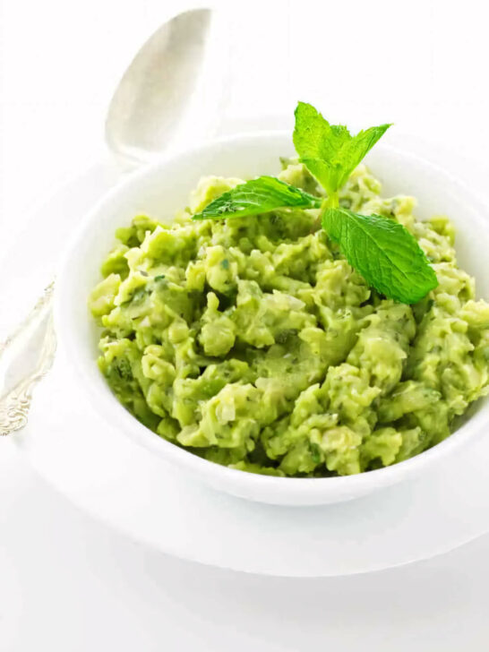 A serving bowl of English mashed peas with mint.