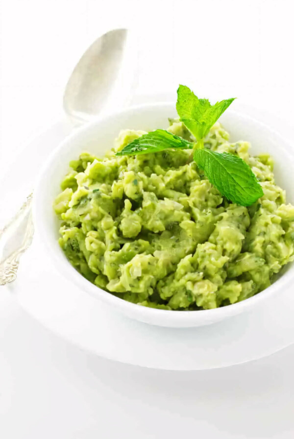 A serving bowl of English mashed peas with mint.