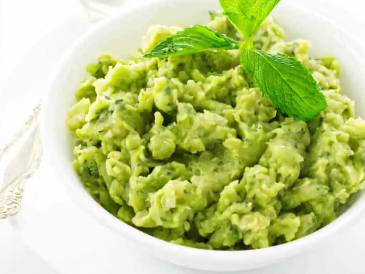 A serving bowl of English mashed peas with mint.