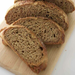 Several slices of rye bread on a cutting board.