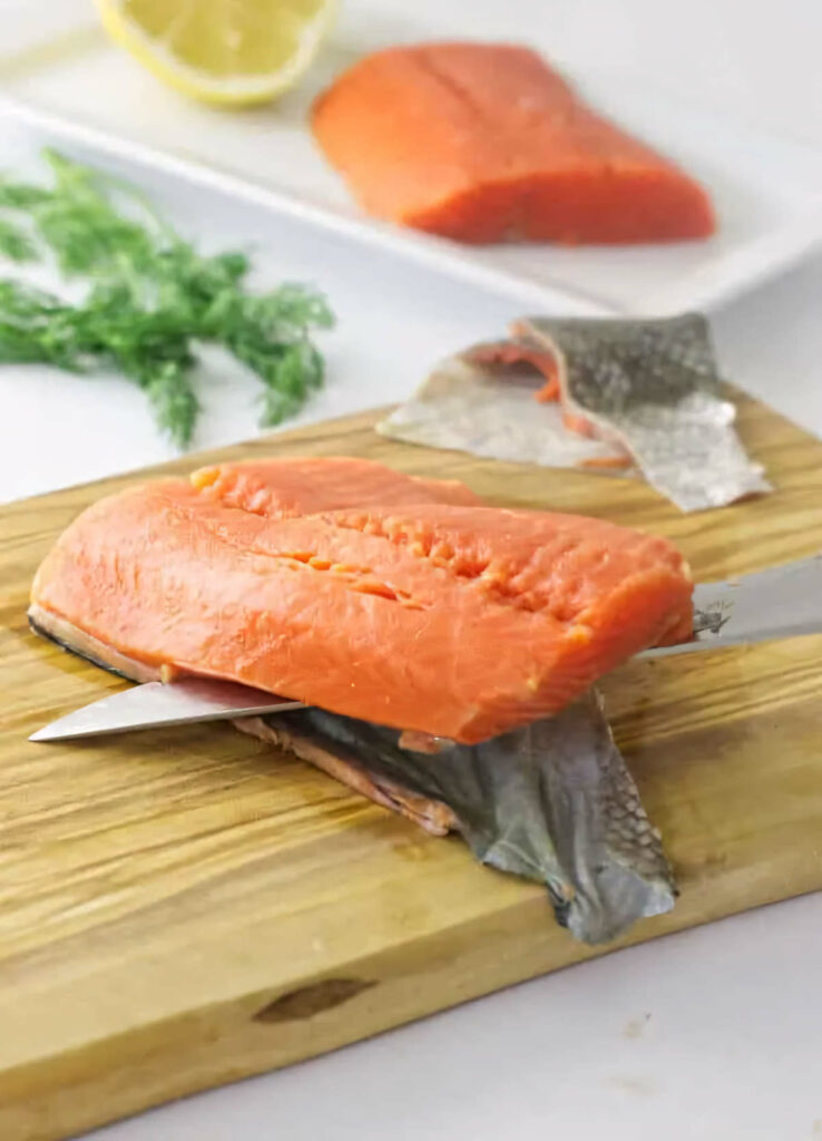 Removing the skin from a salmon fillet before steaming.