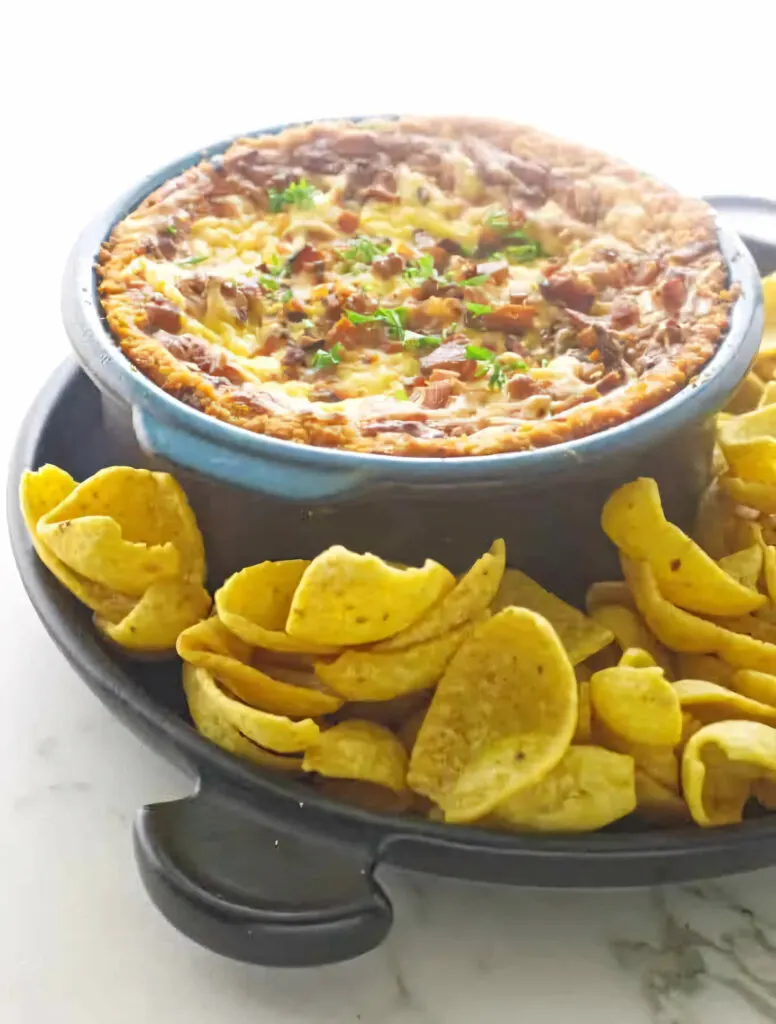 Smoked bean and bacon dip in a warm dish.