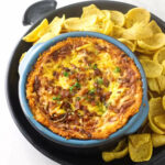 A dish filled with warm bean dip.