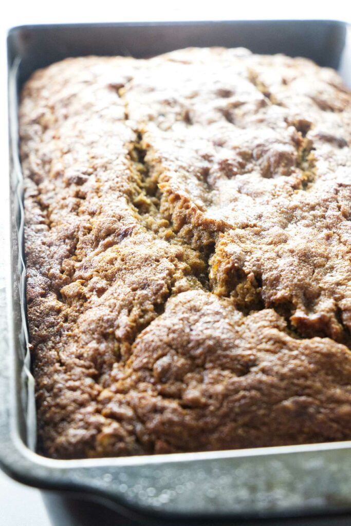 A loaf of spelt banana bread in a bread pan.