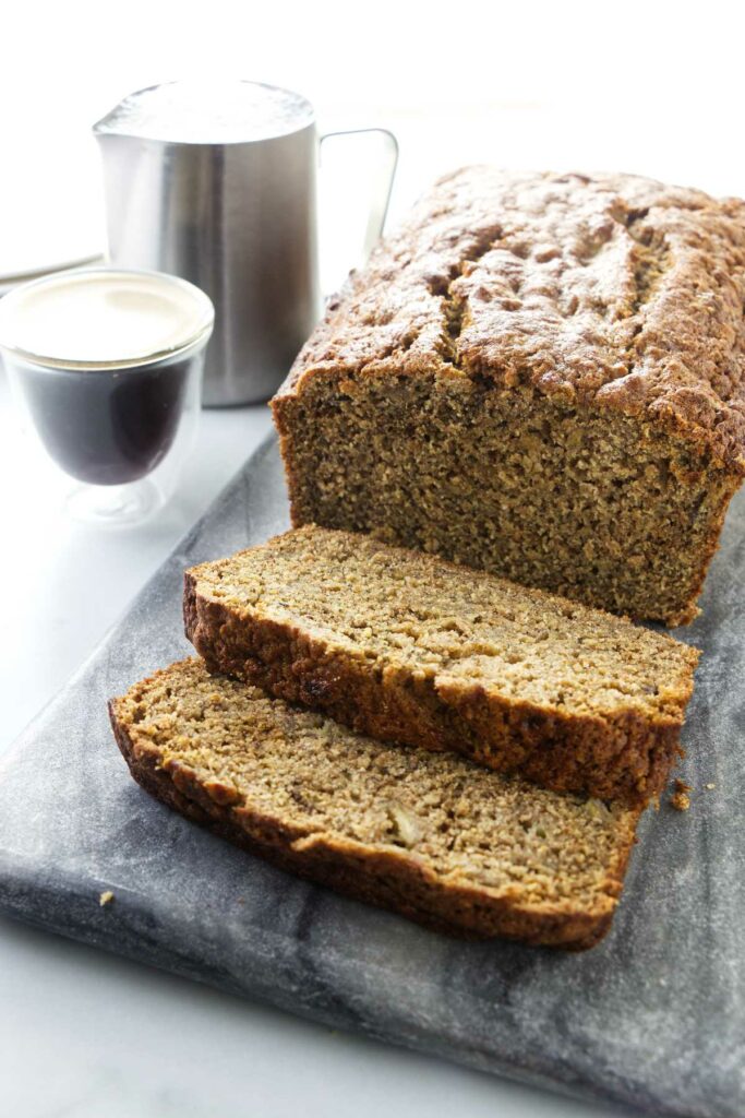 Slices of spelt flour banana bread next to coffee.