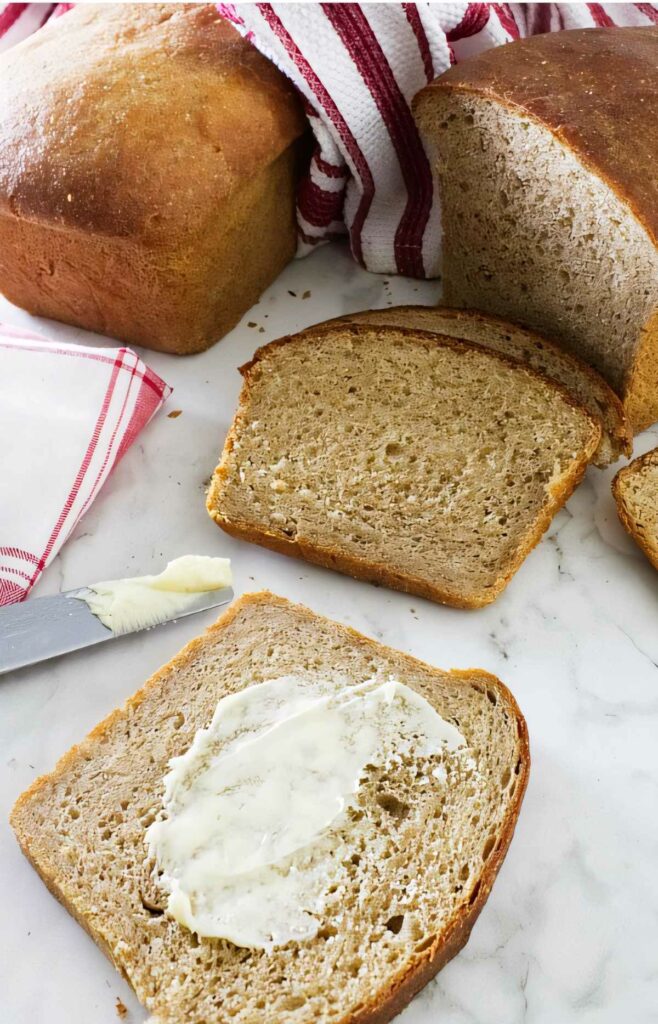 Spreading butter on a slice of bread.