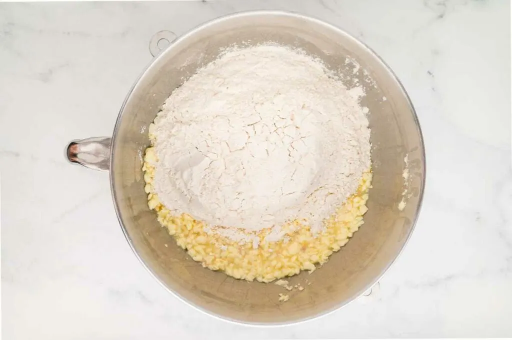 Adding the dry ingredients to the bowl to make the dough.