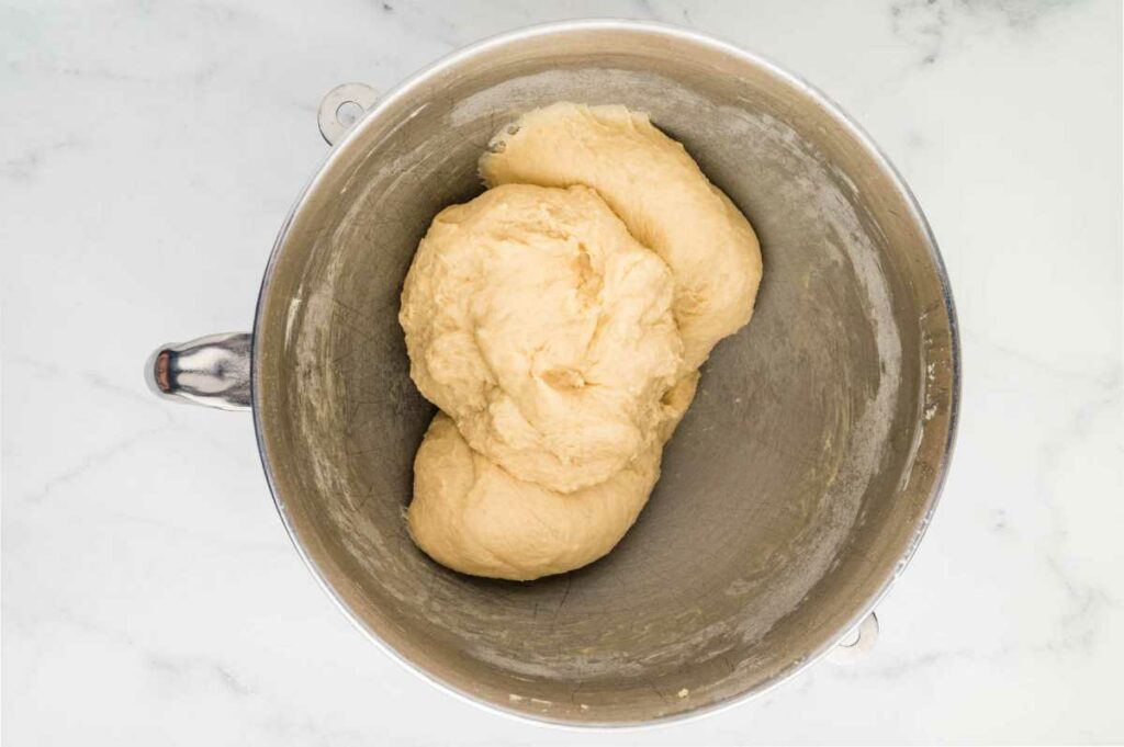 Cinnamon roll dough in a mixing bowl.