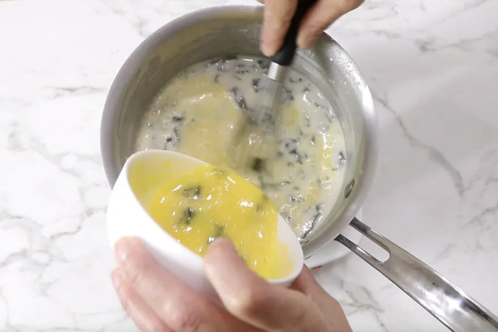 Tempering egg yolks in the ice cream mixture.