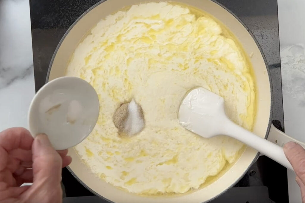 Stirring salt and pepper into the mixture.