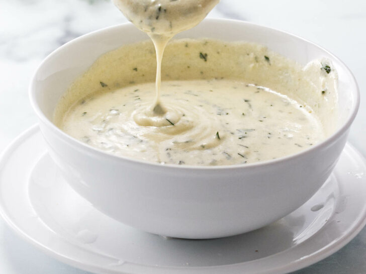 Pouring sauce into a bowl.