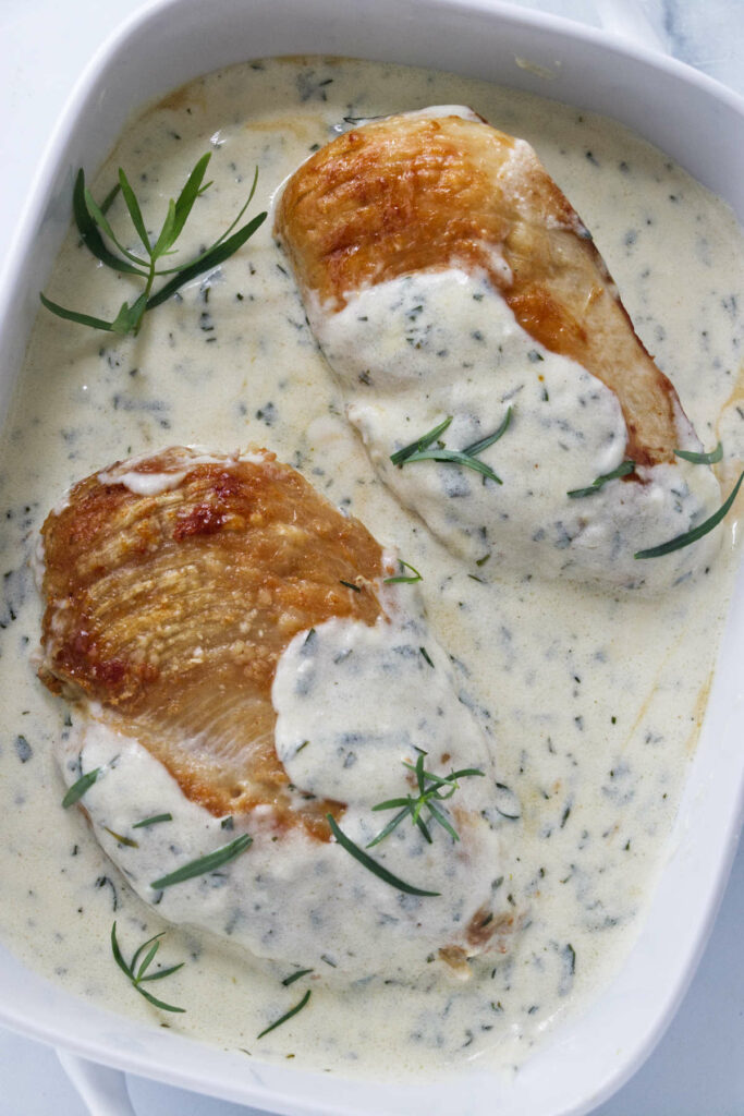 Creamy tarragon chicken in a serving dish.