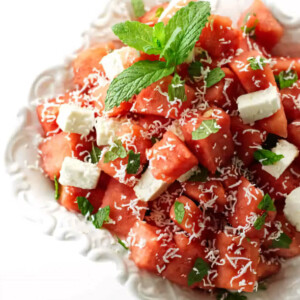 A dish filled with watermelon feta salad with mint.