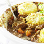 A spoon in a casserole with einkorn dumplings.