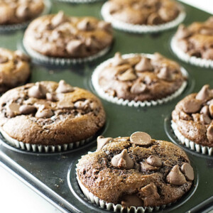 Chocolate einkorn muffins cooling in a muffin tin.