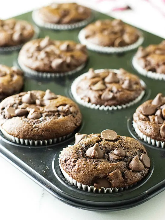 Chocolate einkorn muffins cooling in a muffin tin.