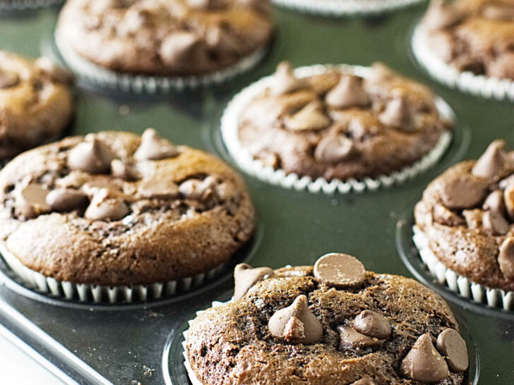 Chocolate einkorn muffins cooling in a muffin tin.