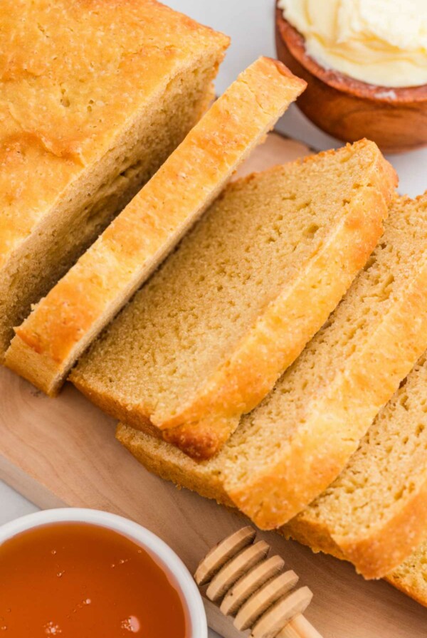 A loaf of einkorn sandwich bread sliced into 1/2 inch thick slices.