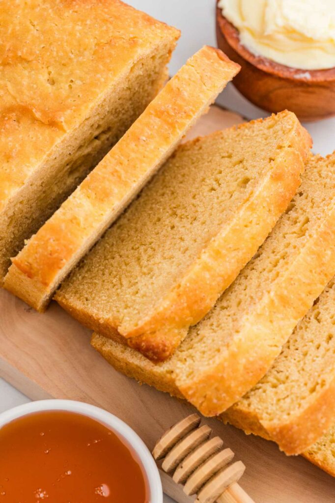 A loaf of einkorn sandwich bread sliced into 1/2 inch thick slices.