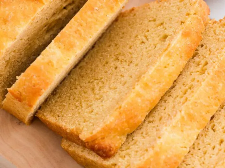 A loaf of einkorn sandwich bread sliced into 1/2 inch thick slices.