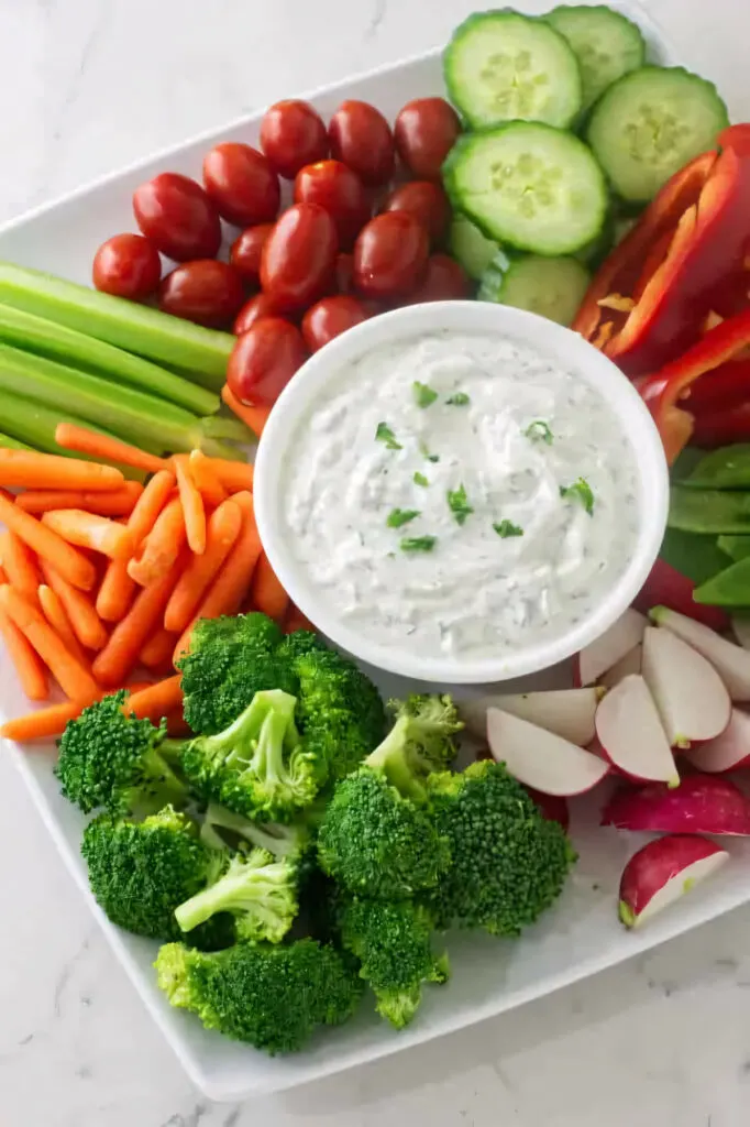 Dill yogurt dip made with Greek yogurt on a platter with fresh veggies.