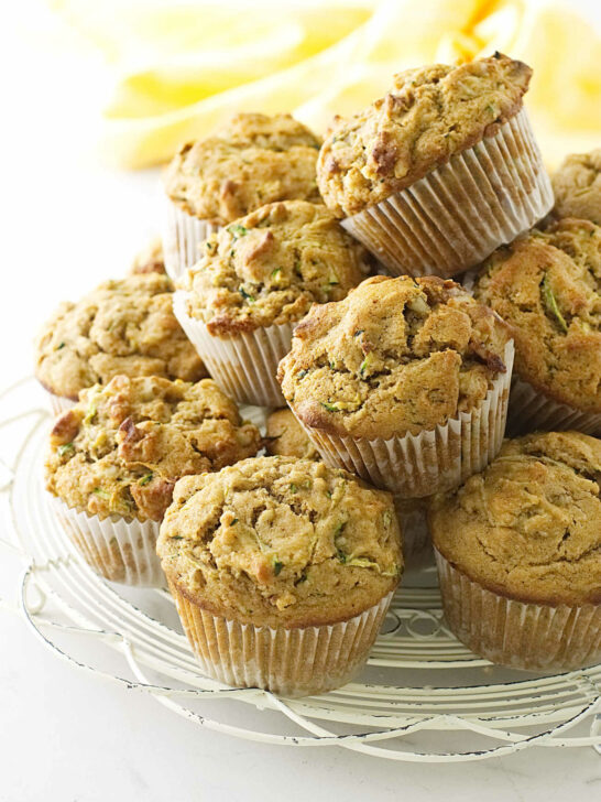 A stack of kamut zucchini muffins on a white cooling rack.