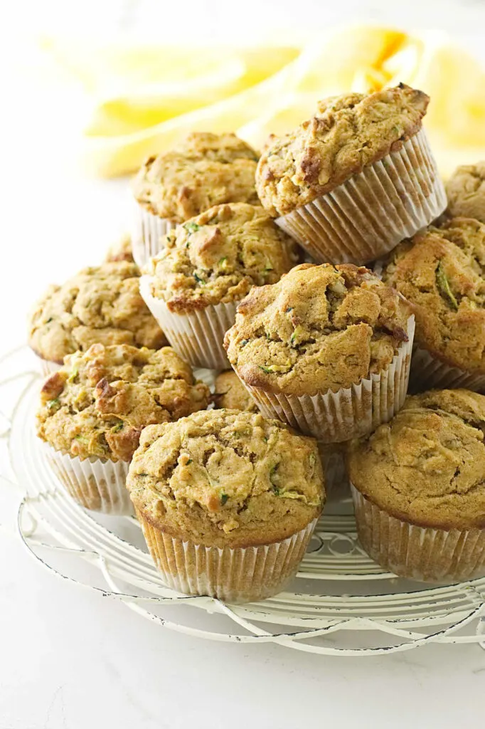 A stack of kamut zucchini muffins on a white cooling rack.