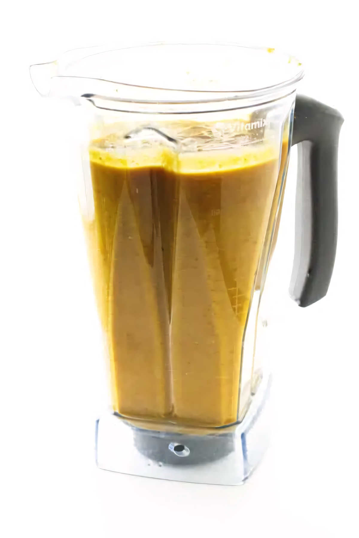 A blender filled with pumpkin coconut soup.