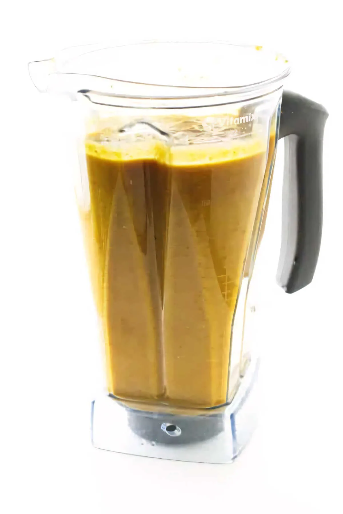 A blender filled with pumpkin coconut soup.