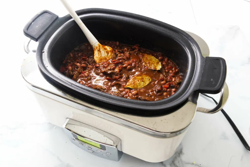 A crockpot filled with beef chili beans.