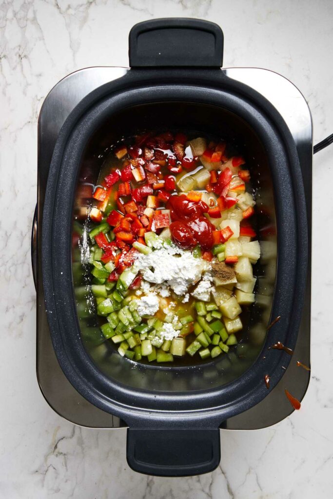 Placing the sauces and cornstarch in the slow cooker.