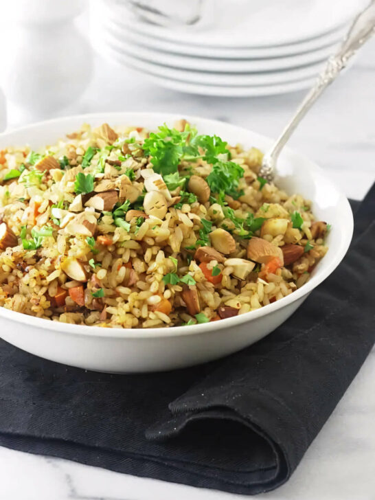 A spoon in a bowl of rice pilaf made with germinated rice pilaf.