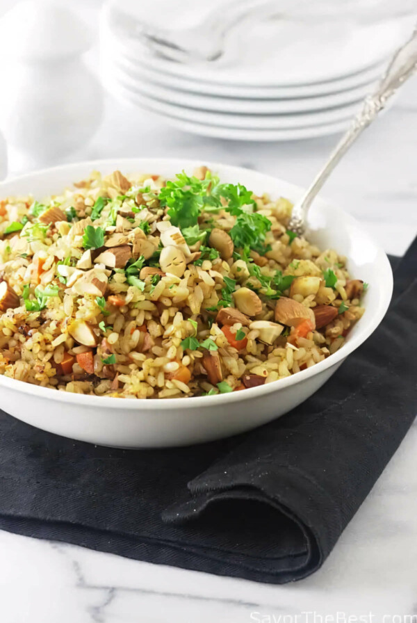 A spoon in a bowl of rice pilaf made with germinated rice pilaf.