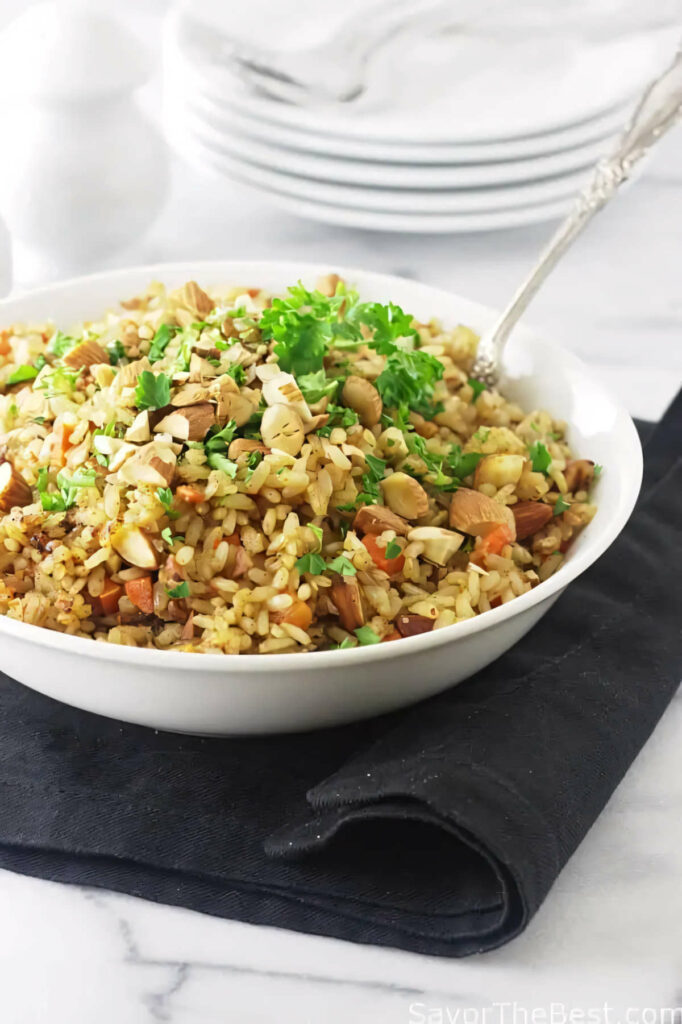 A spoon in a bowl of rice pilaf made with germinated rice pilaf.