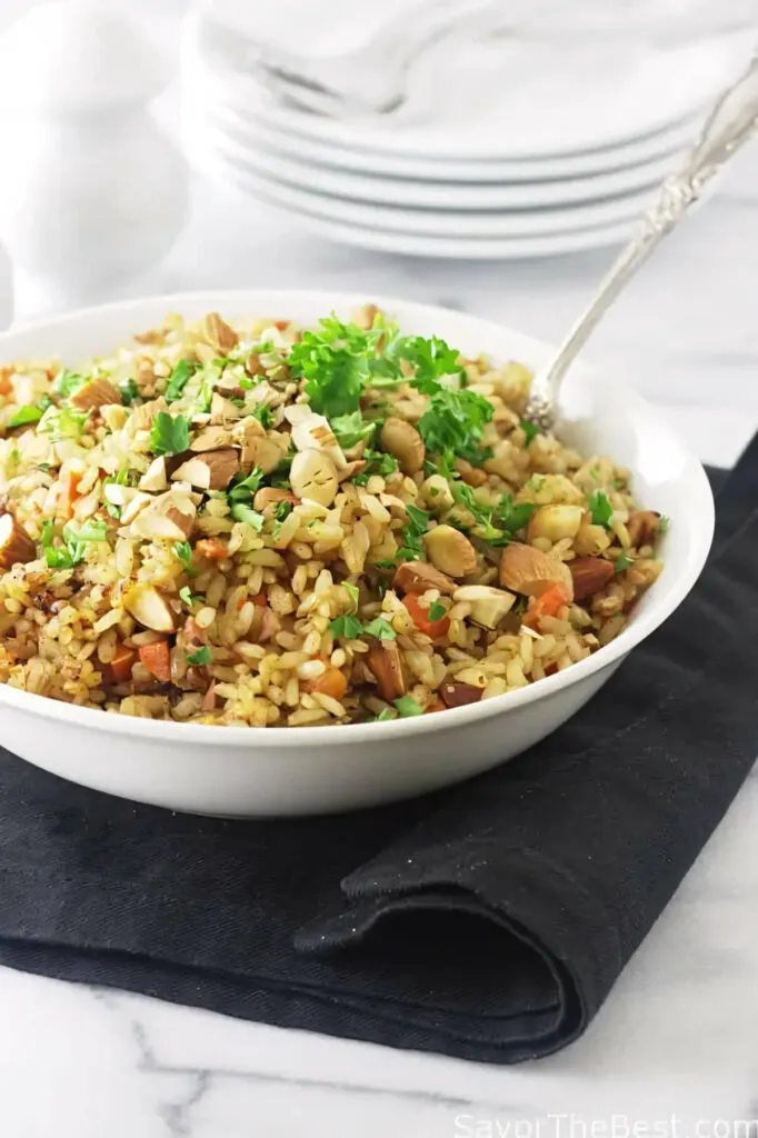 A spoon in a bowl of rice pilaf made with germinated rice pilaf.