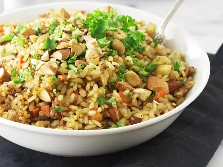 A spoon in a bowl of rice pilaf made with germinated rice pilaf.